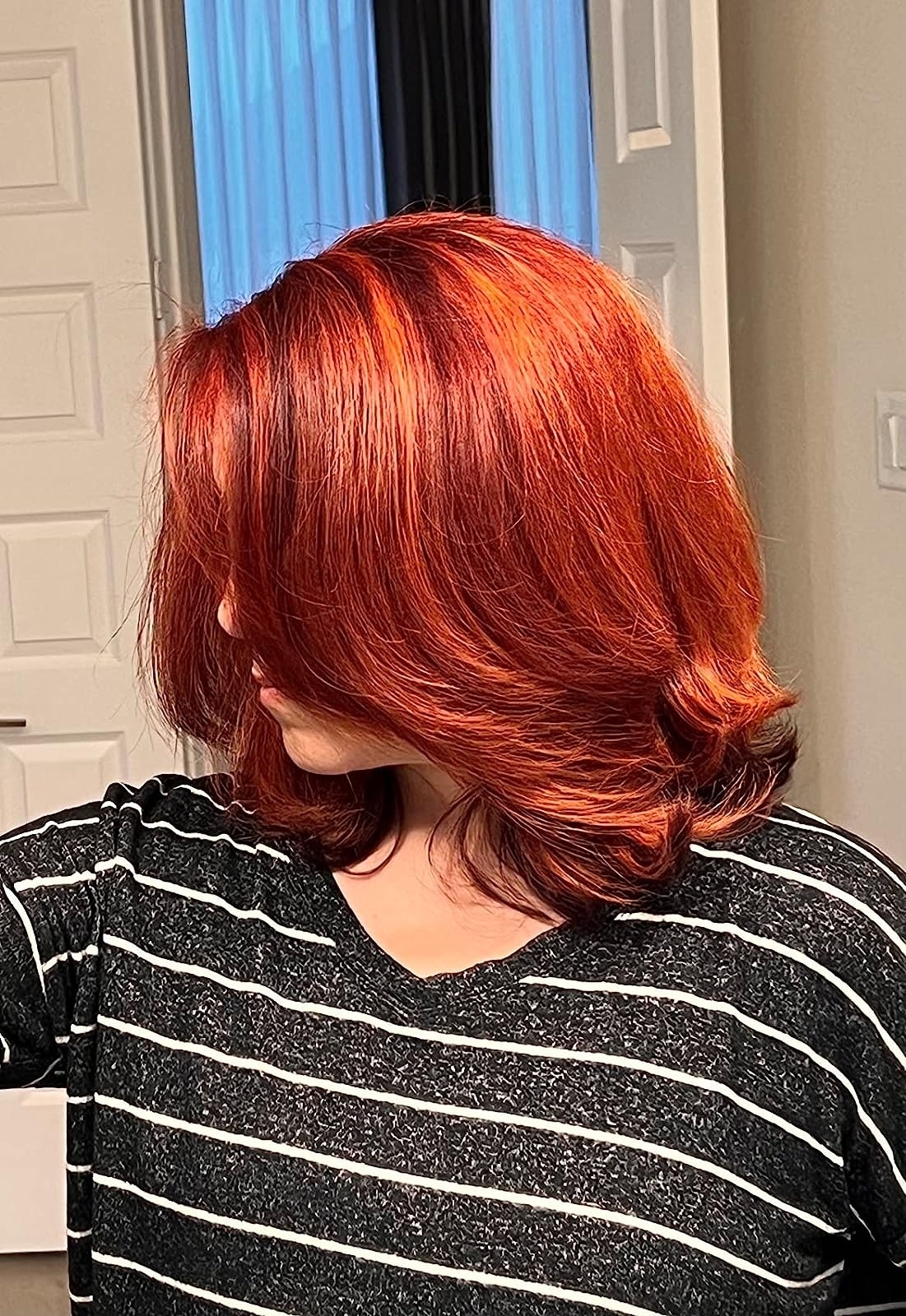 reviewer with bright red, straight, and shiny hair