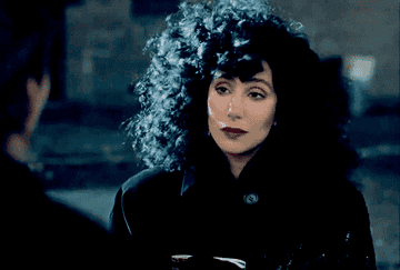 A GIF image of Cher in the movie mentioned, with black hair