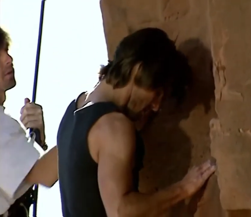 Tom climbing a rock