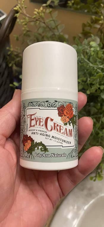 reviewer holding the bottle of eye cream
