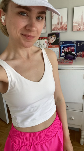 BuzzFeeder in a white V-neck cropped sports bra top