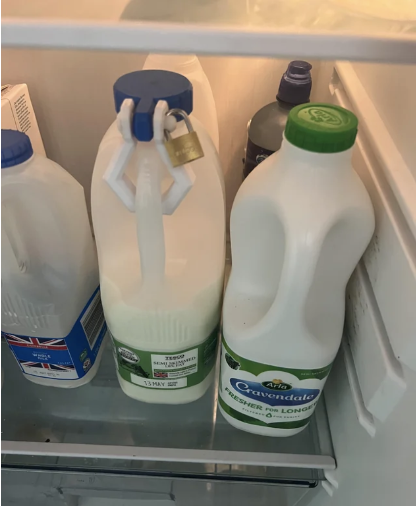 A bottle of milk in the fridge with a padlock on the top