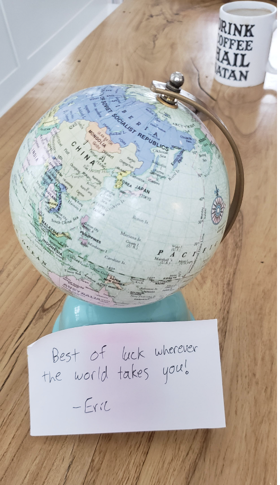 A globe with note: &quot;Best of luck wherever the world takes you!: