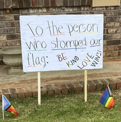 Sign with Pride color highlights: &quot;To the person who stomped our flag: Be kind, love wins!&quot;