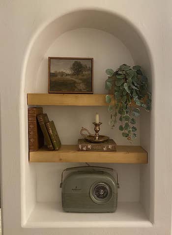 reviewer's painting placed in arched shelf space