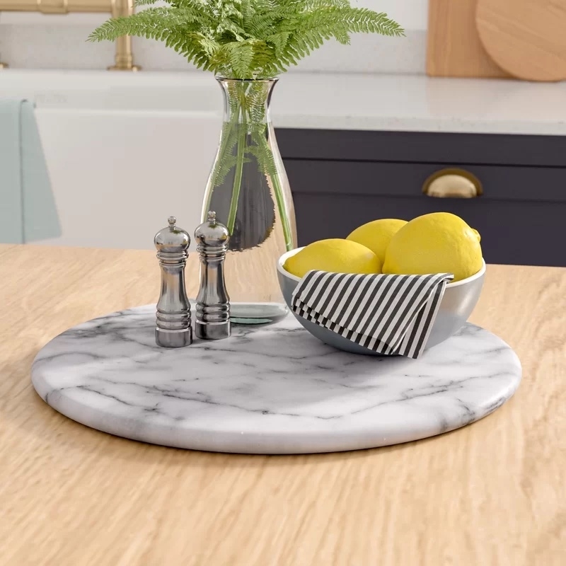 The marble lazy Susan with a vase, bowl of lemons and a salt and pepper shaker