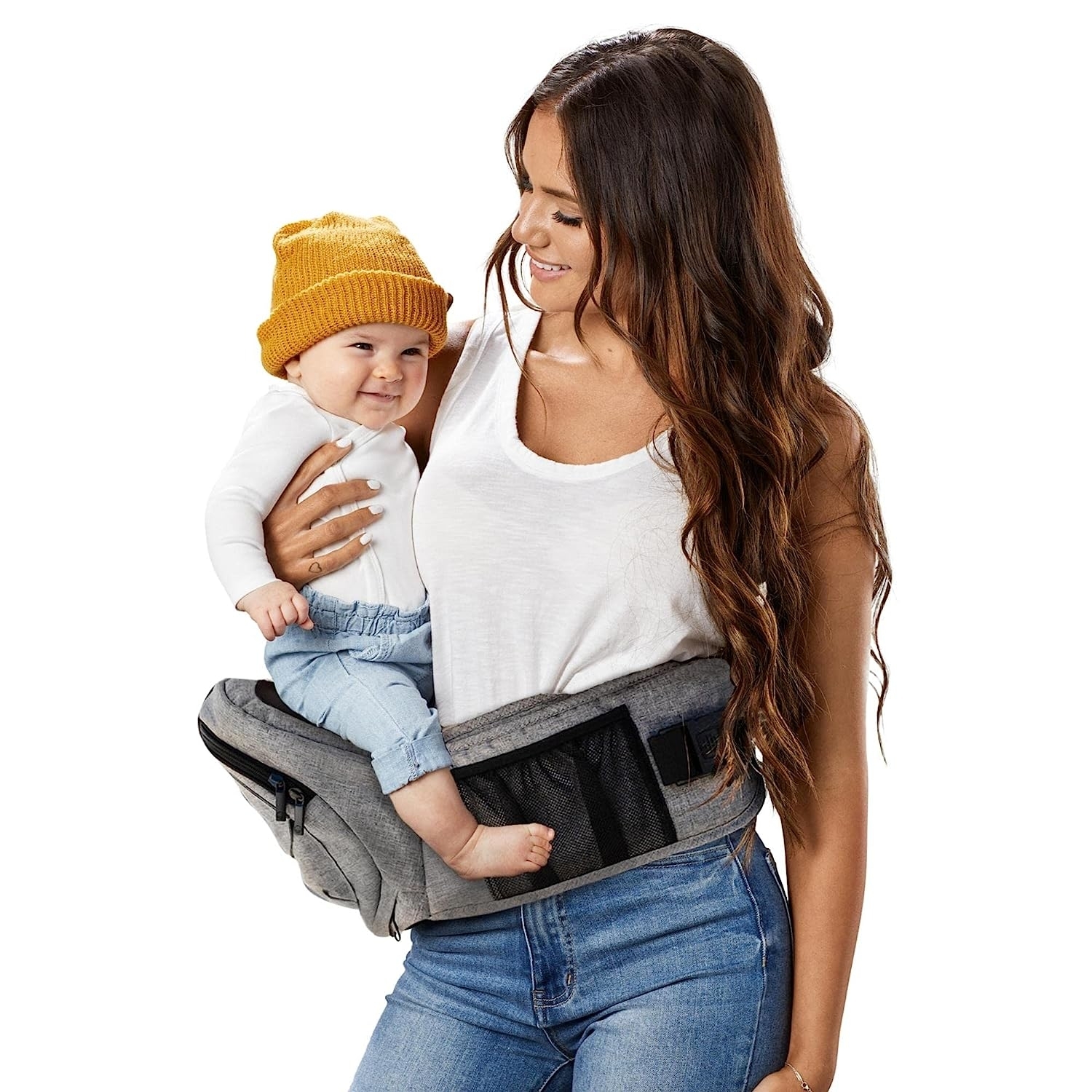 A model with the carrier around their waist and cradling a baby