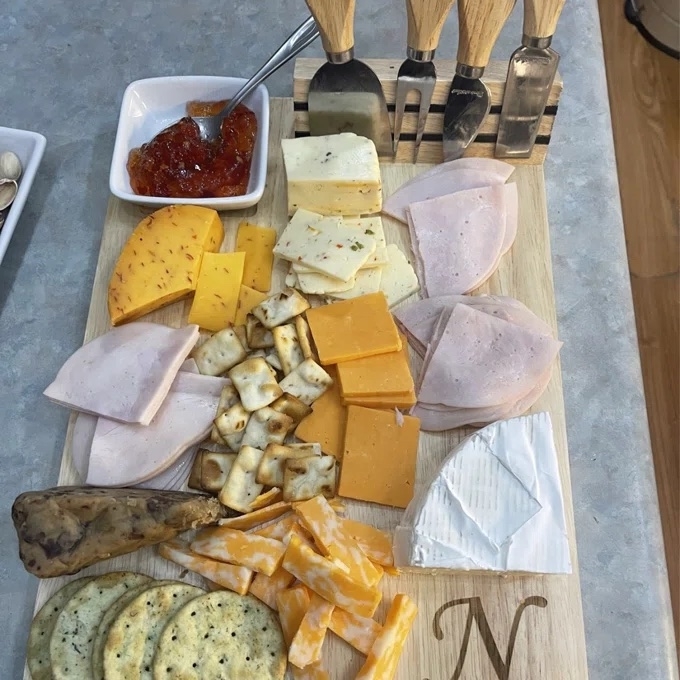Reviewer image of the wooden board with a charcuterie spread