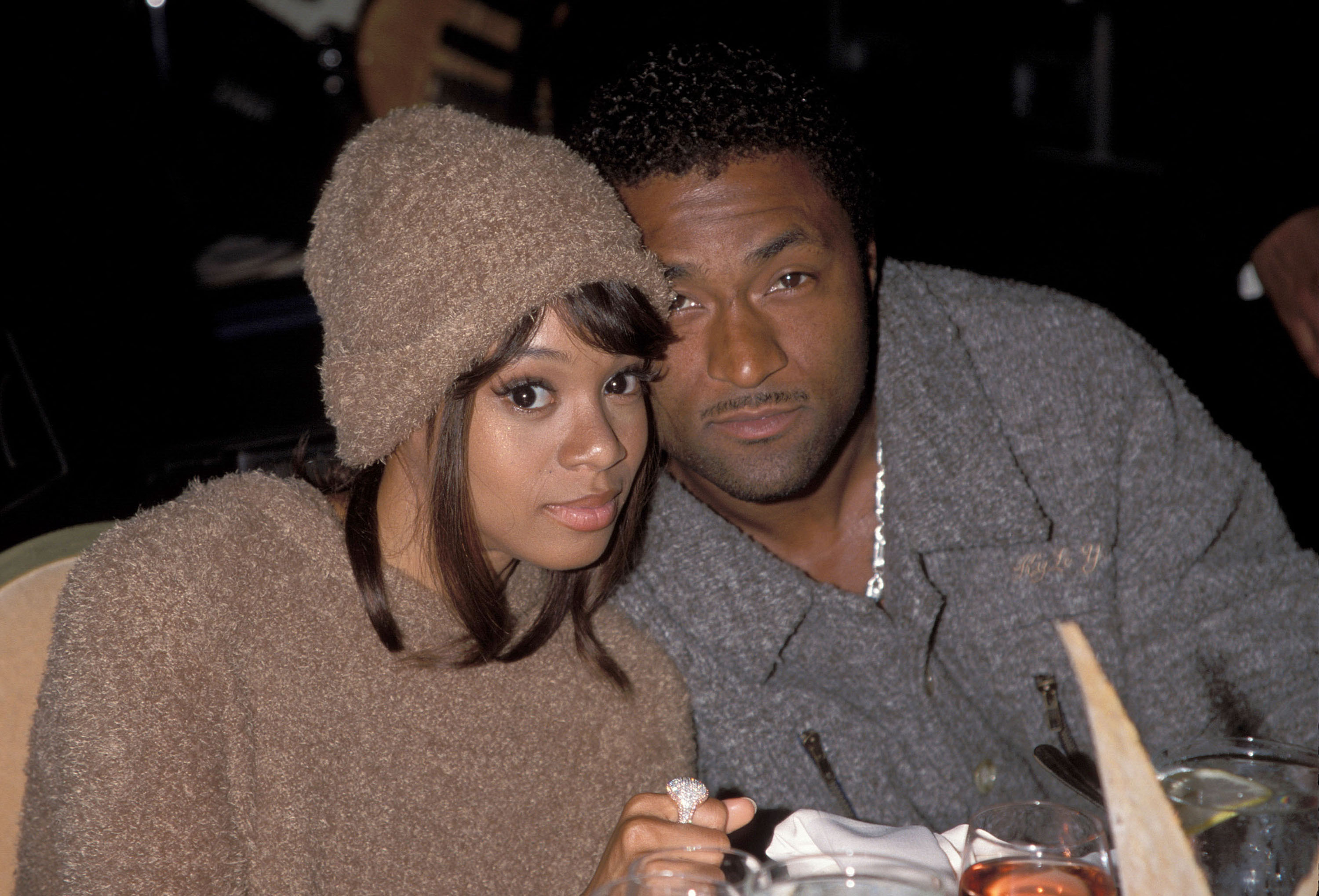Andre Rison leaning into Lisa Left Eye Lopes for a photo