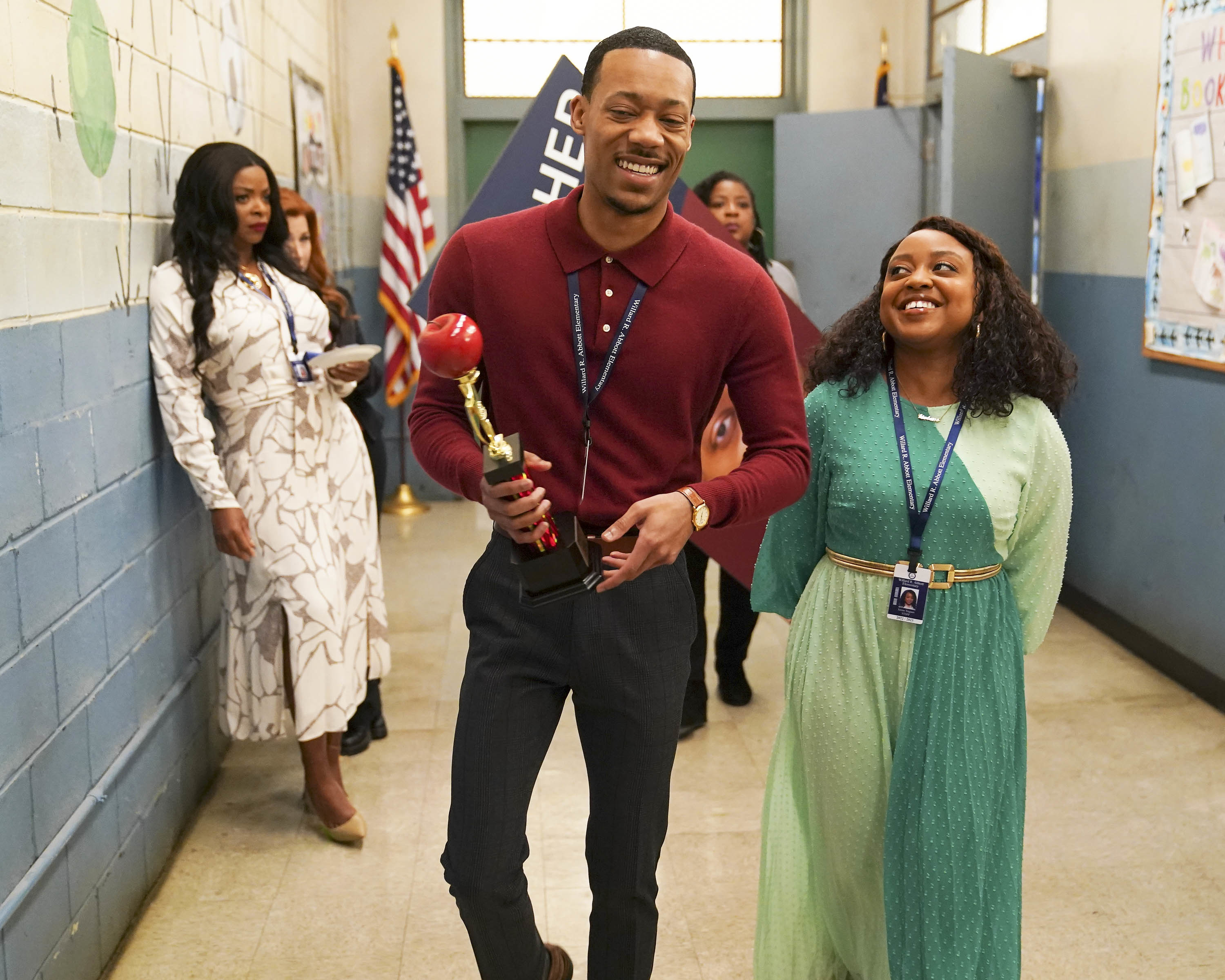 Tyler James Williams as Gregory Eddie and Quinta Brunson as Janine Teagues walking down the school hallway in a scene from Abbot Elementary