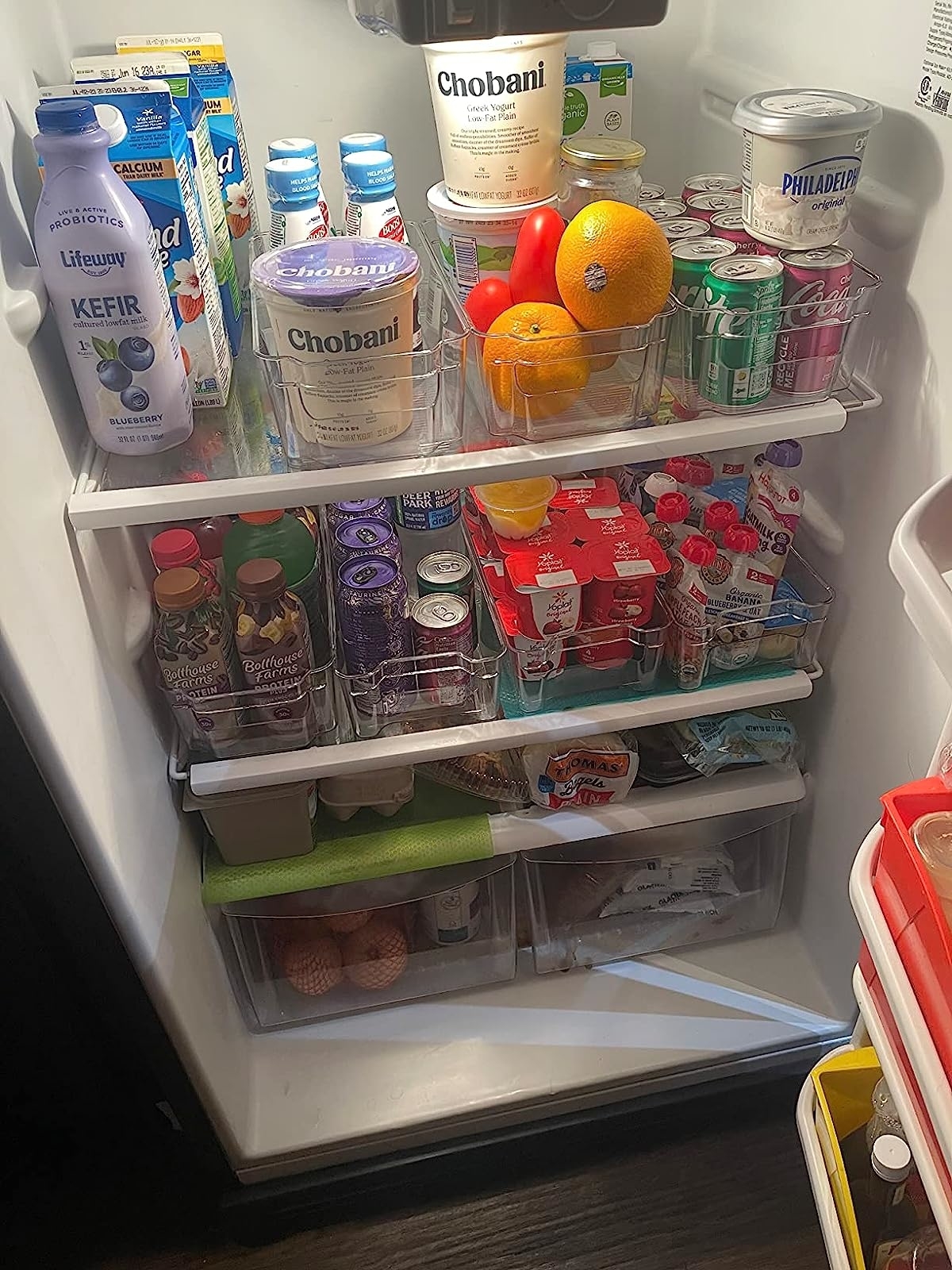 a reviewer photo of a fridge organized using the clear bins