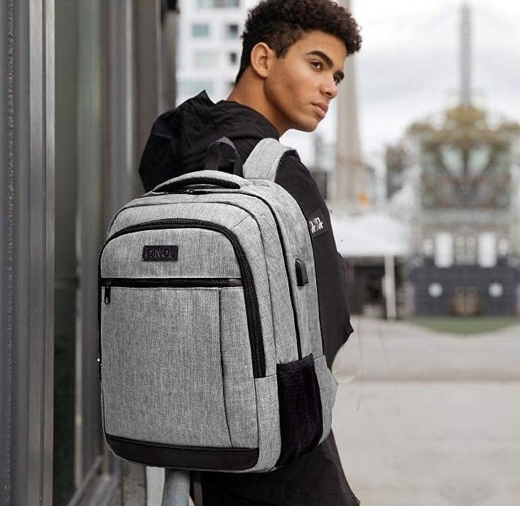 model wearing gray laptop backpack