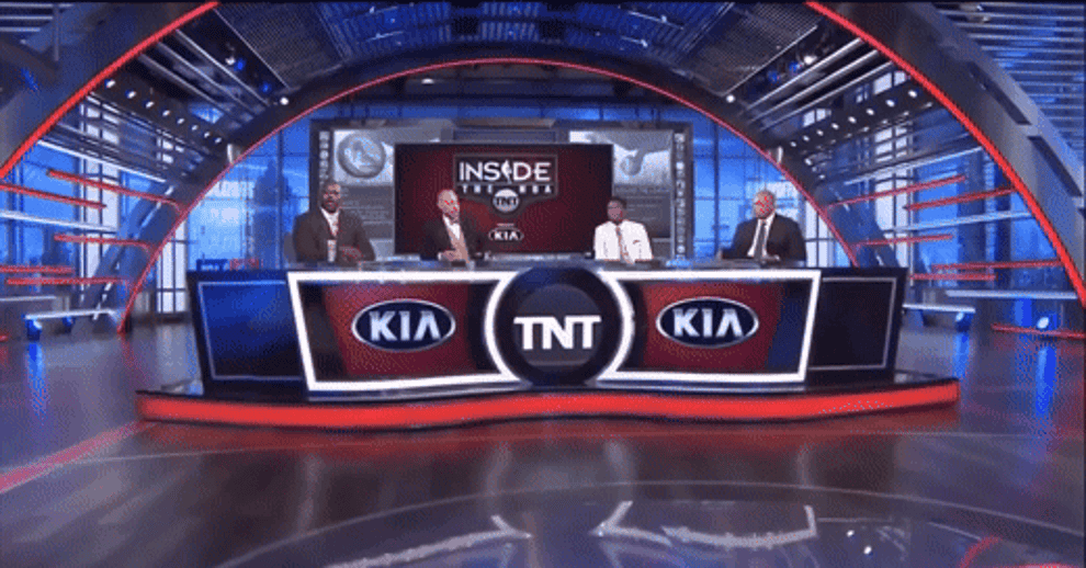Shaq sits frozen while the other people at the desk converse