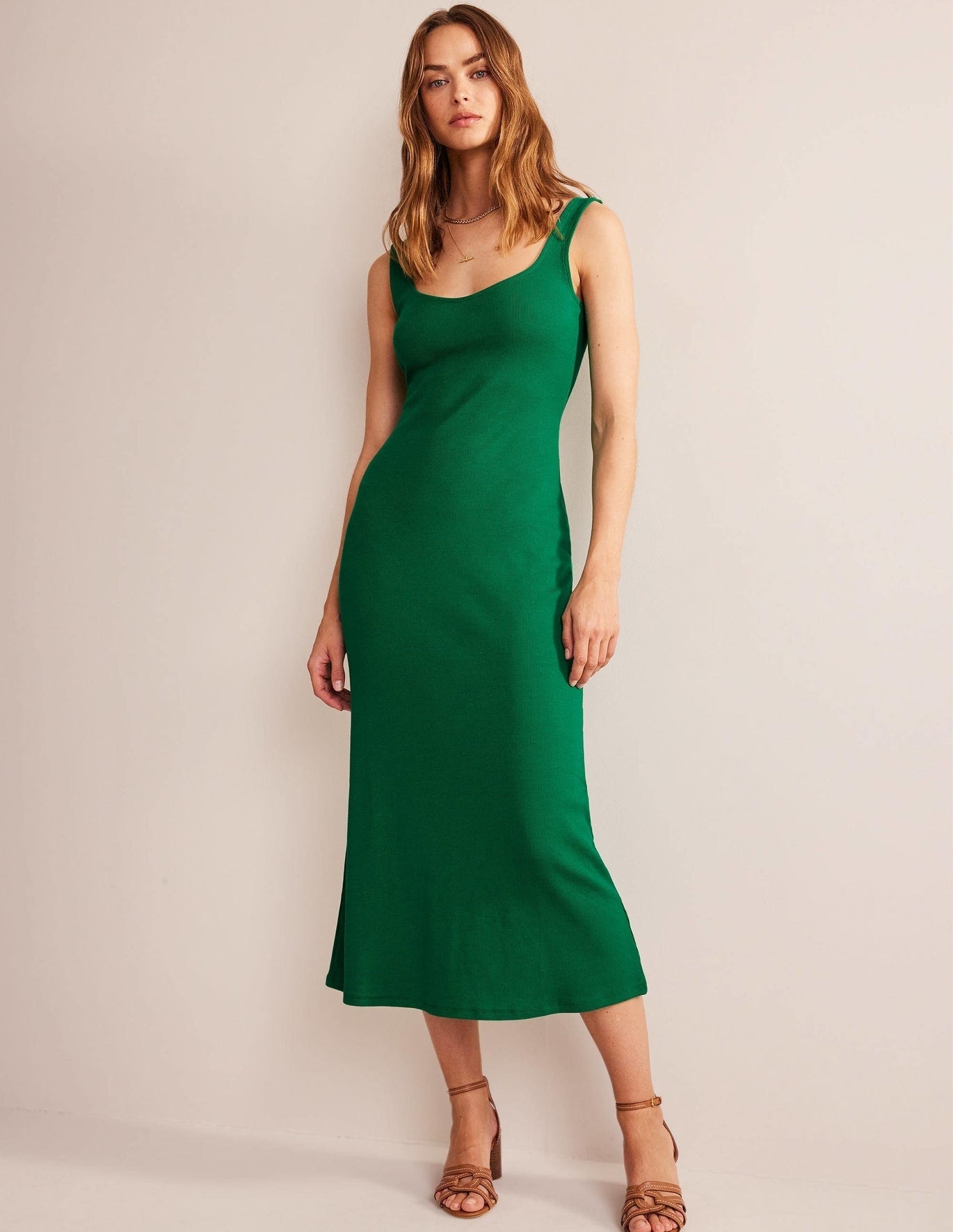 A model wearing a green dress.