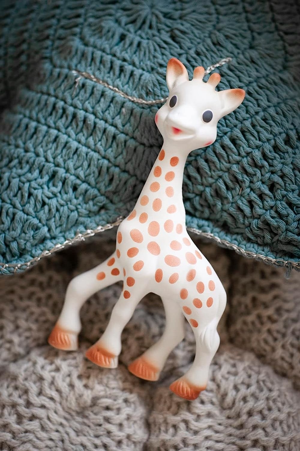 sophie giraffe toy on blankets