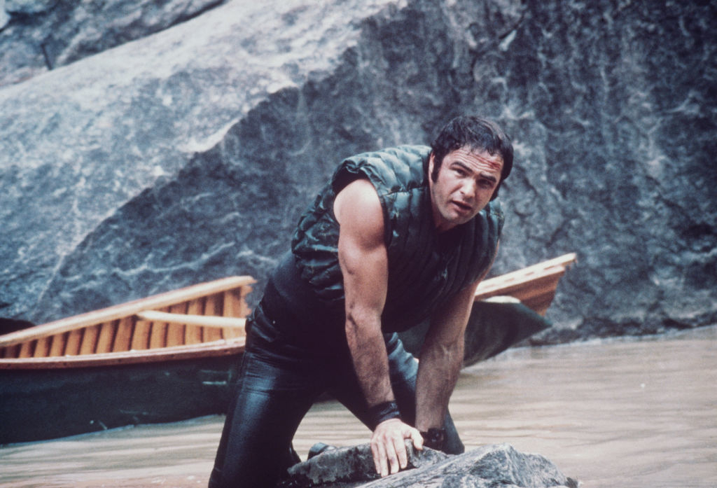 burt standing in the water with the canoe behind him