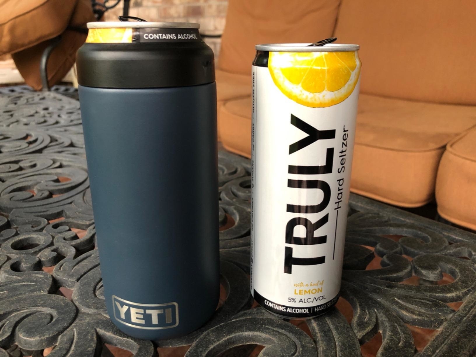 reviewer&#x27;s navy can holder next to a can of truly hard seltzer