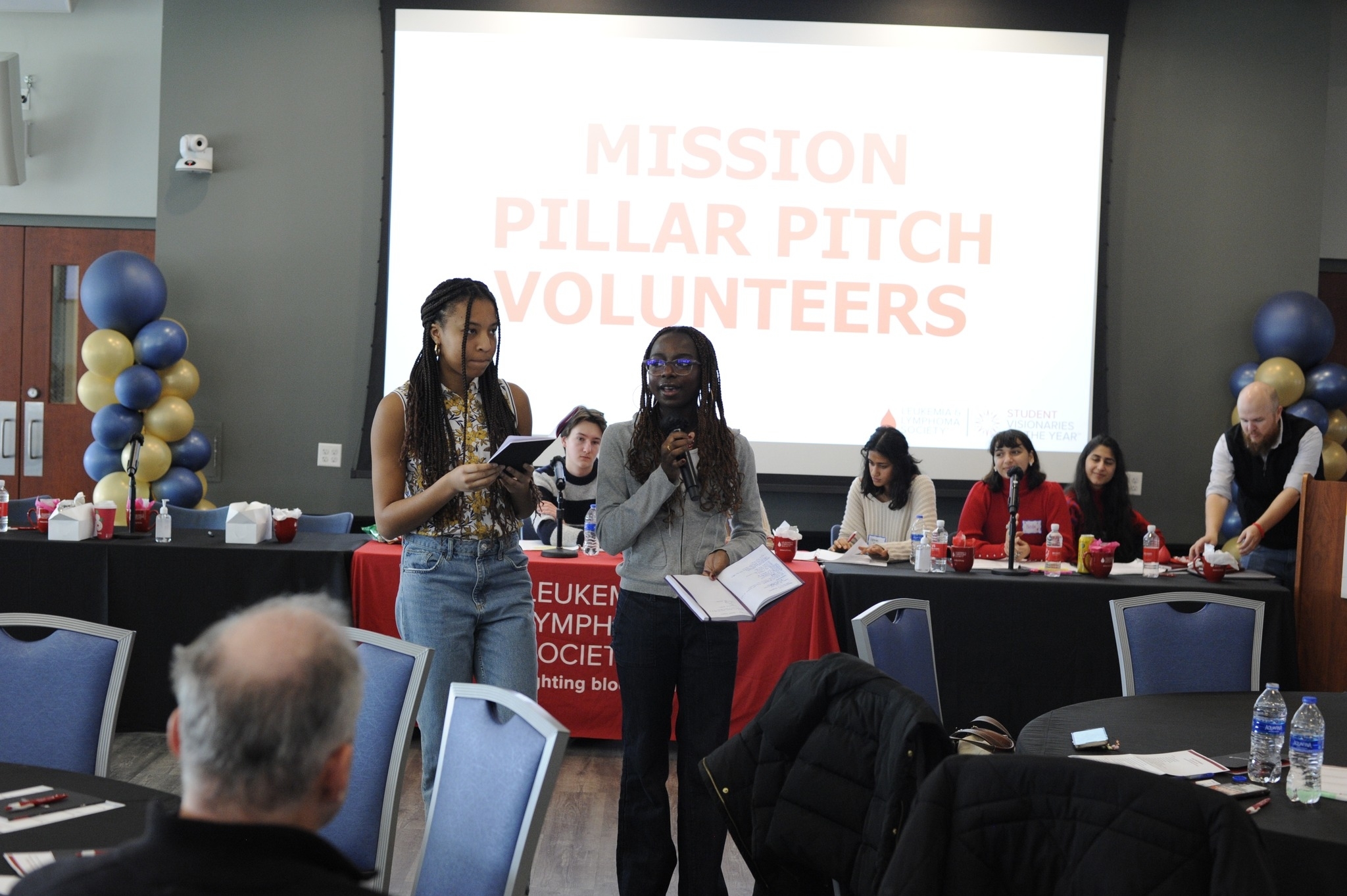 Two students giving a presentation on mission pillar pitches.