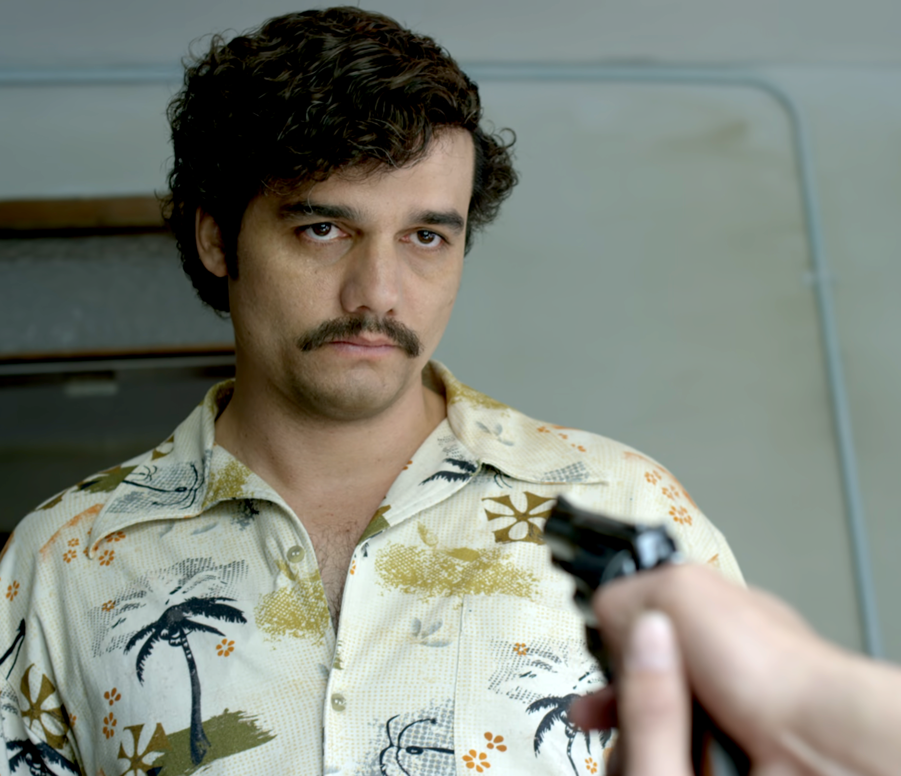 Wagner Moura as Pablo Escobar in &quot;Narcos&quot;  with a gun pointed towards him