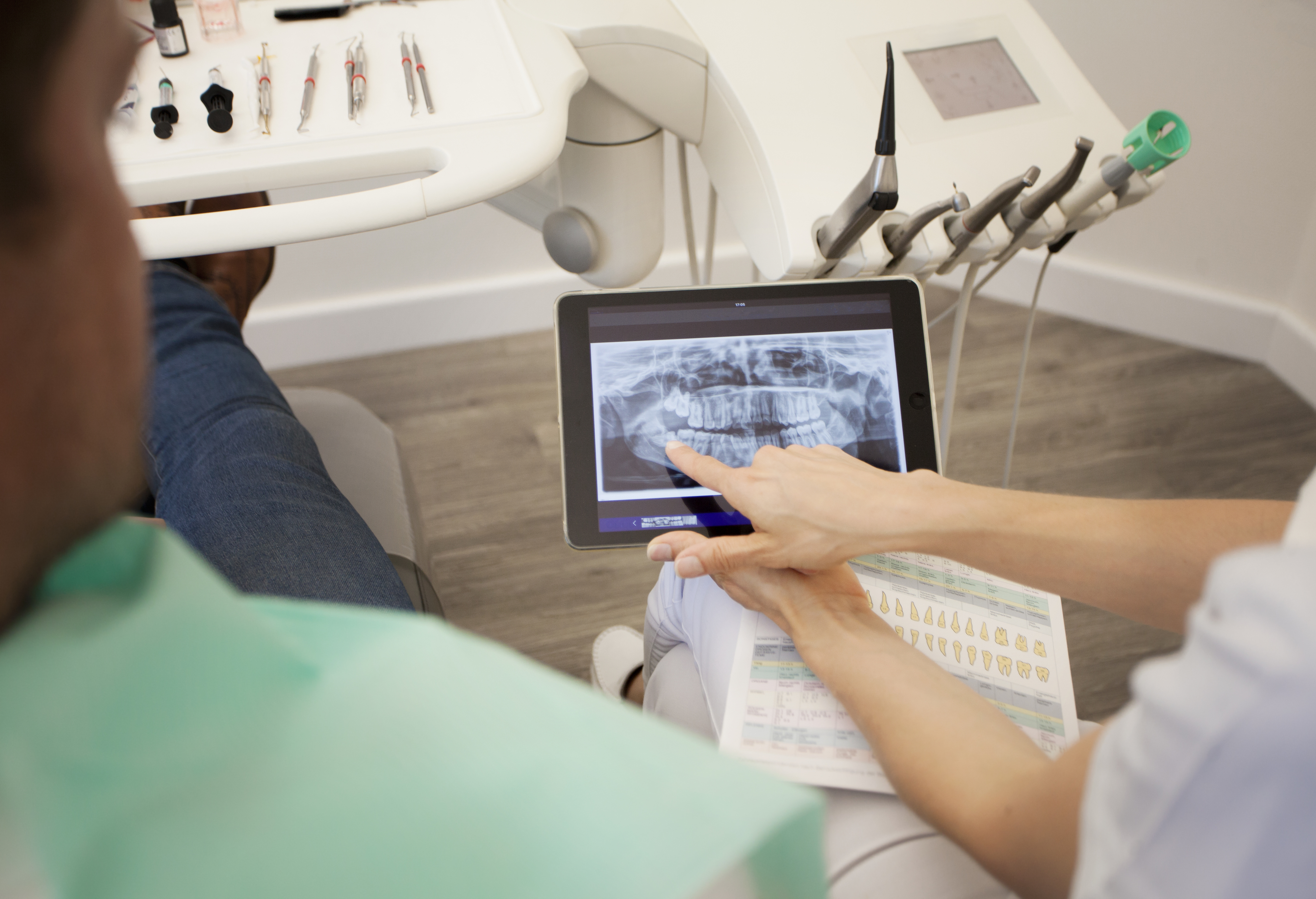 dentist going over x ray images with patient
