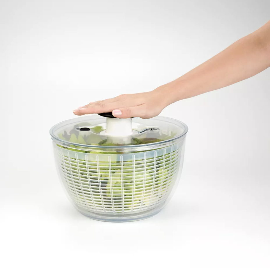 a person using a salad spinner
