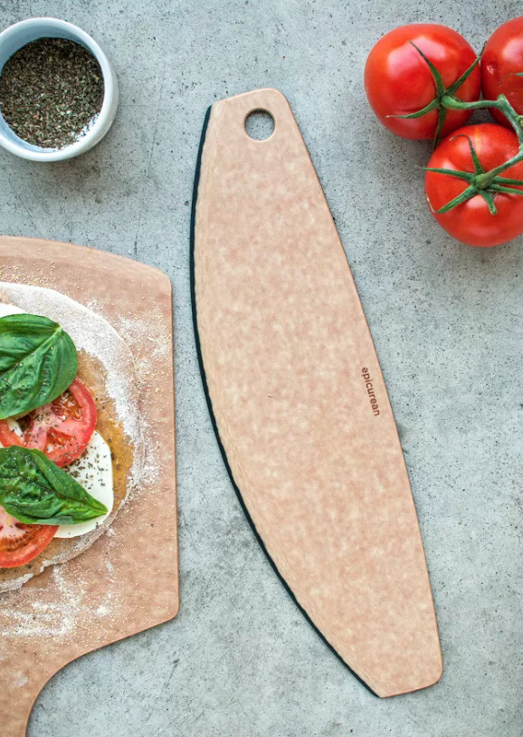 a 16 inch pizza cutter next to pizza dough and tomatoes