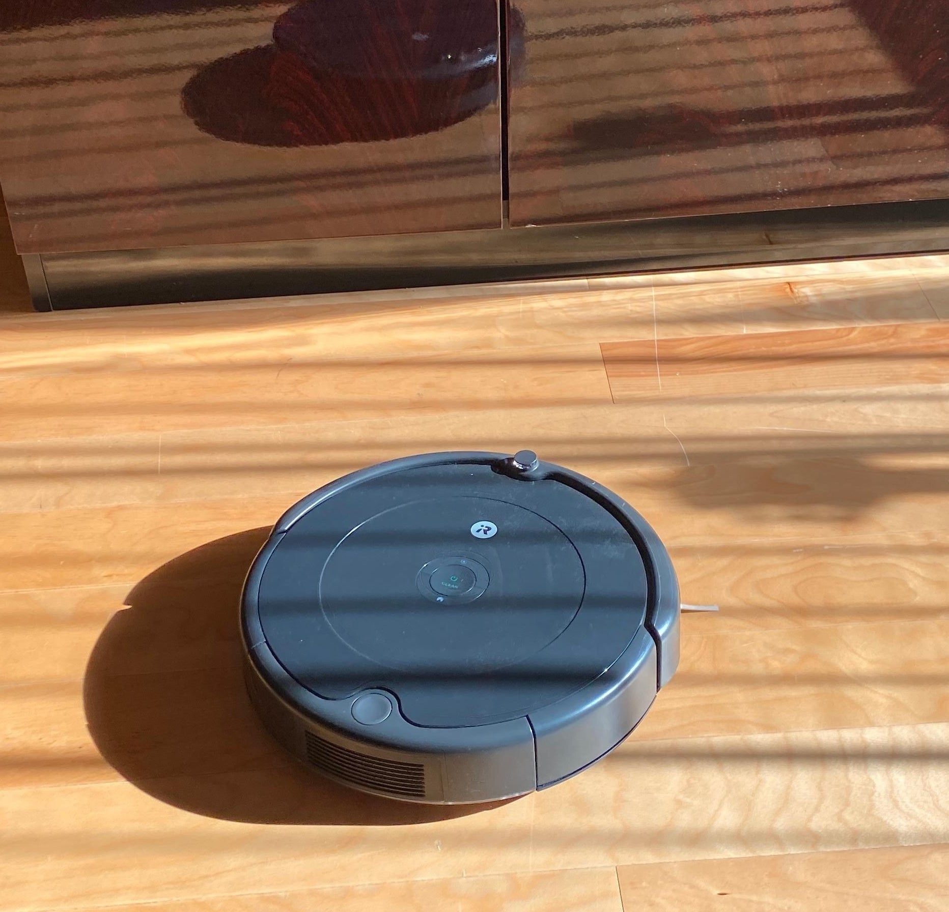 a reviewer photo of the roomba on the floor