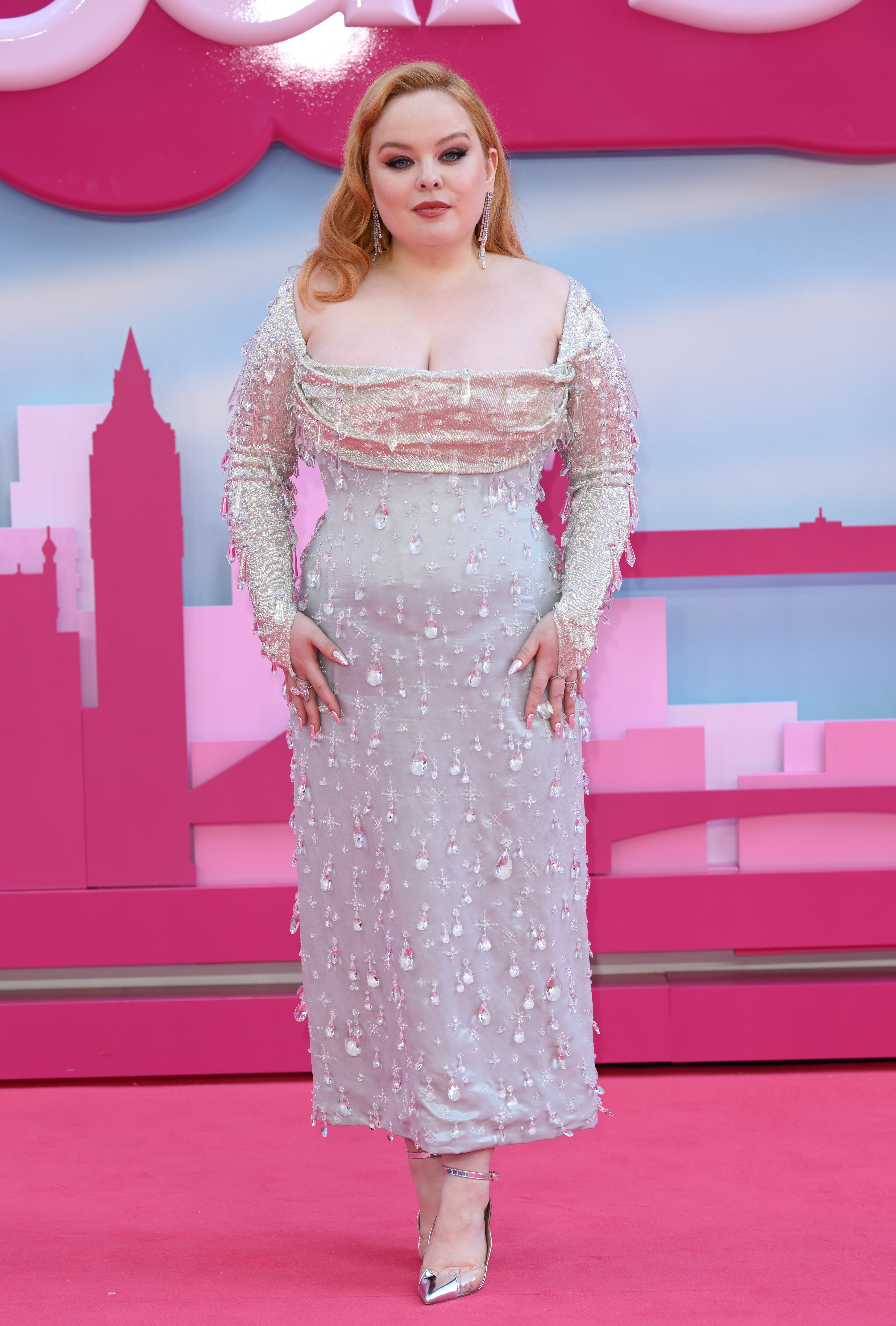 Close-up of Nicola on the pink carpet in the long-sleeved, ankle-length dress