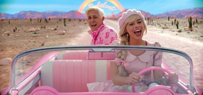 Margot Robbie and Ryan Gosling as Barbie and Ken in a car
