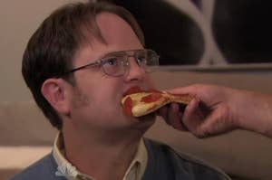 Dwight from The Office eating pizza.
