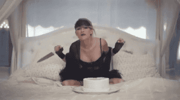 Taylor Swift stabbing a cake