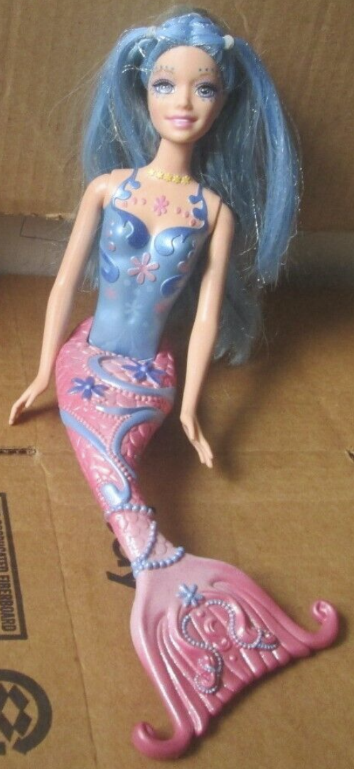 A closeup of a Mermaid Barbie with disheveled hair