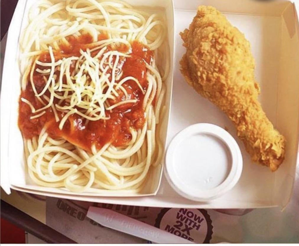 spaghetti and fried chicken in a cardboard box