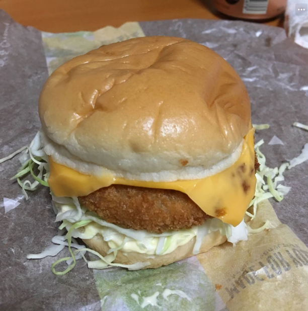 fried croquette on a burger with american cheese and lettuce