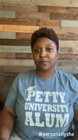 A woman wearing a &quot;Petty University Alum&quot; T-shirt