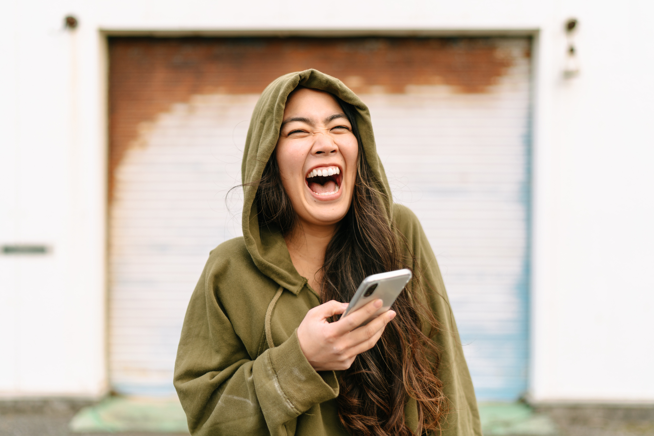 woman laughing at her phone