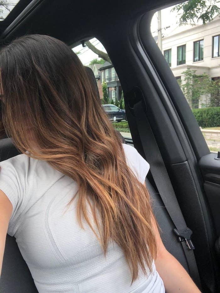 a reviewer with wavy hair after utilizing the conceal
