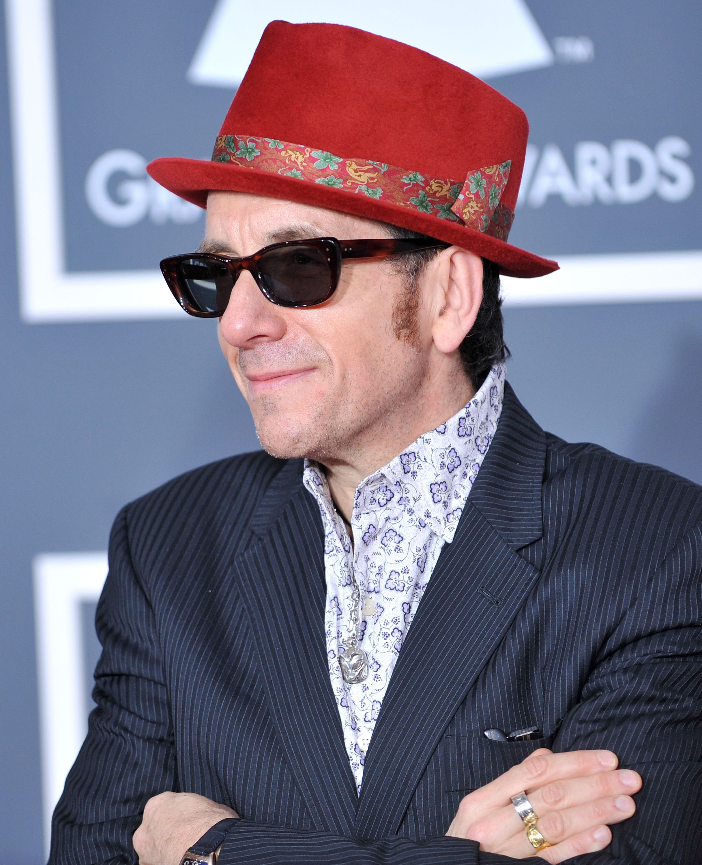 Elvis Costello posing on the Grammys red carpet