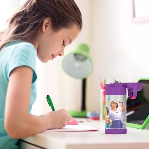 Child model writes next to a water bottle