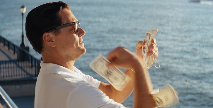 Leonardo DiCaprio throwing money around in The Wolf of Wall Street