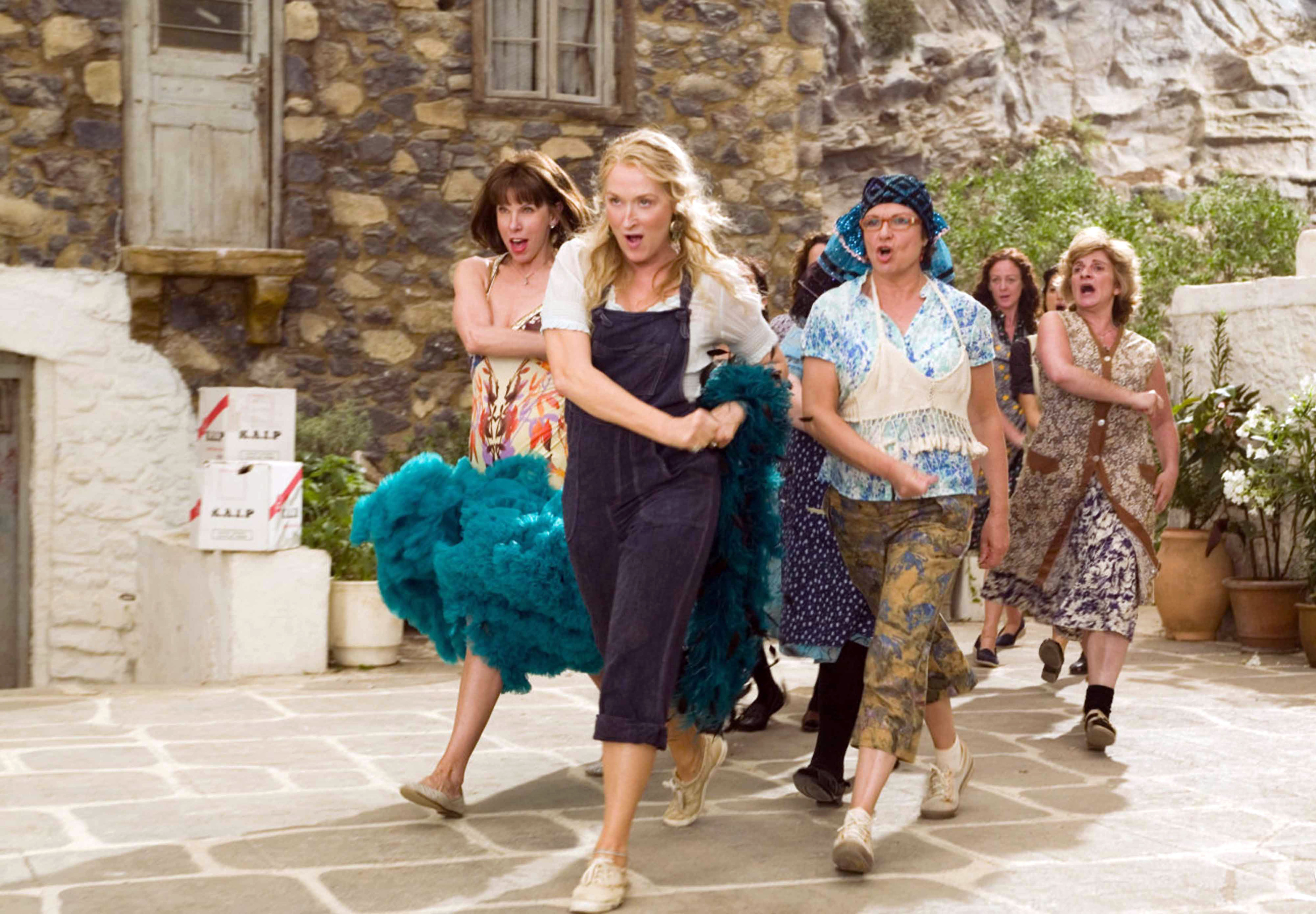 Meryl Streep and a bunch of people walking behind her in Mamma Mia!