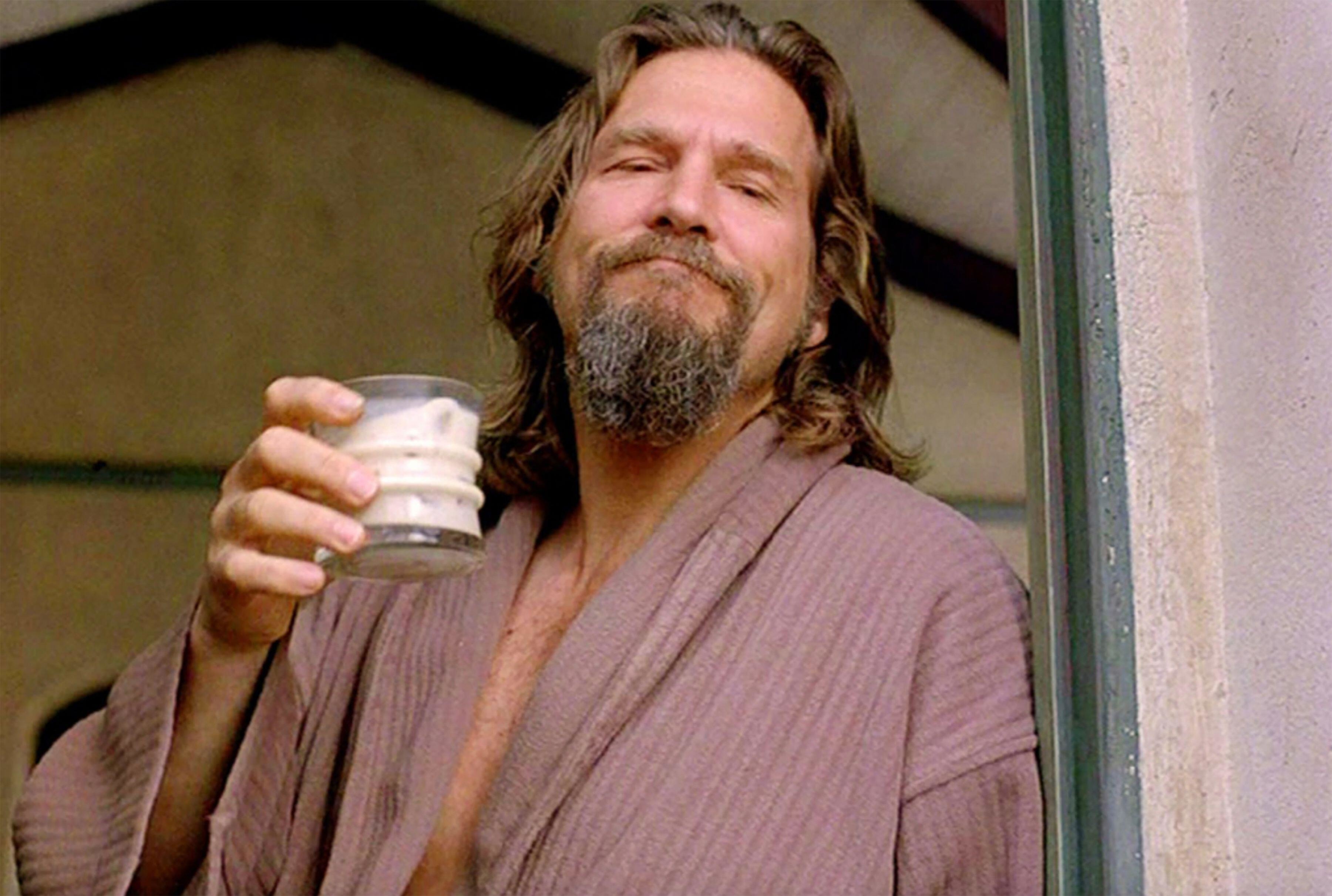 Jeff Bridges holding a cup and wearing a robe in The Big Lebowski