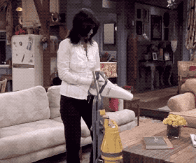 GIF of Monica cleaning her vacuum with a hand vacuum in &quot;Friends&quot;