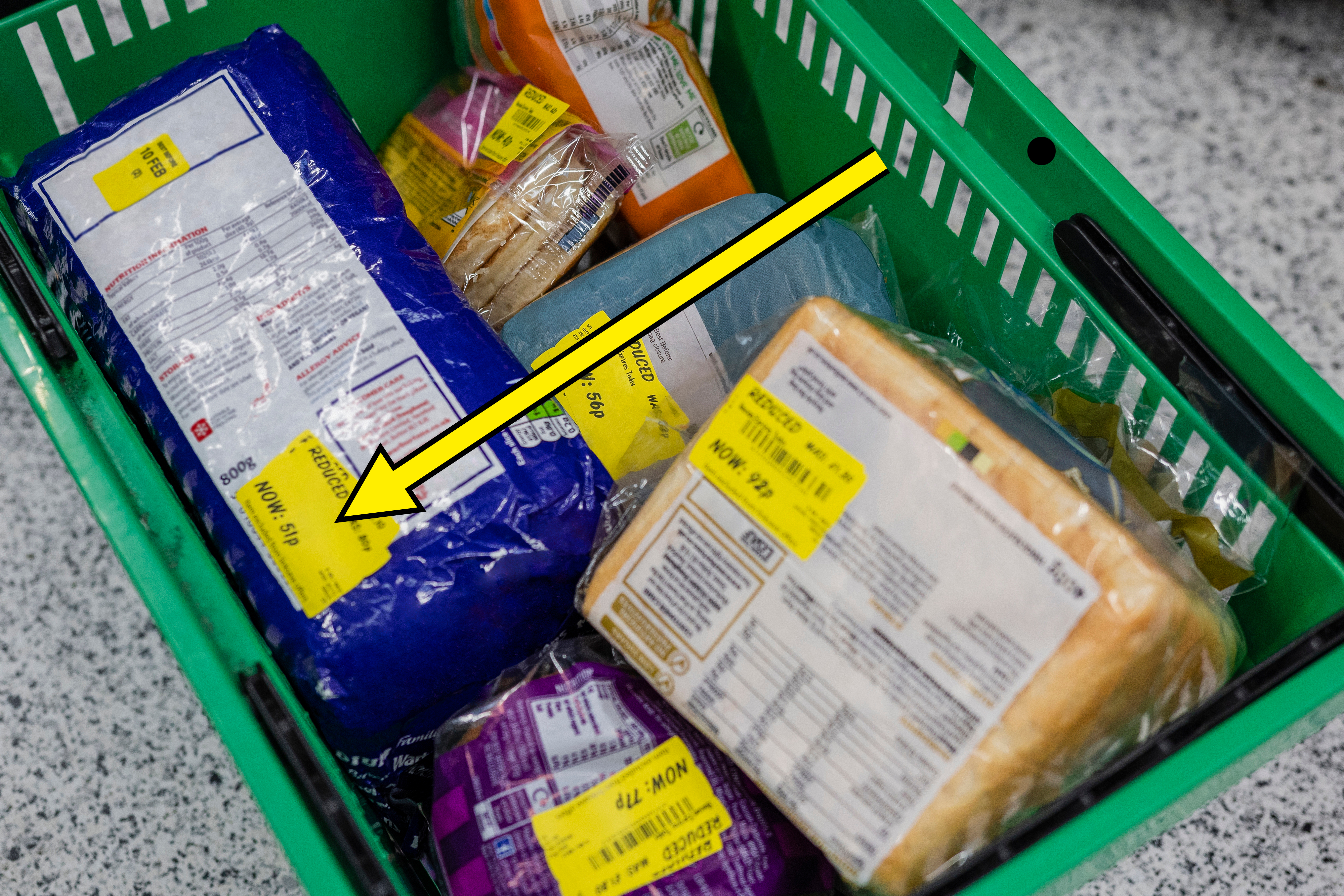 cart full of on sale grocery items with yellow stickers