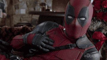 Deadpool laying on his side and stroking his chest