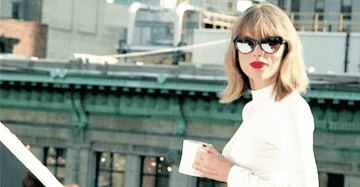 GIF of Taylor swift holding a coffee mug