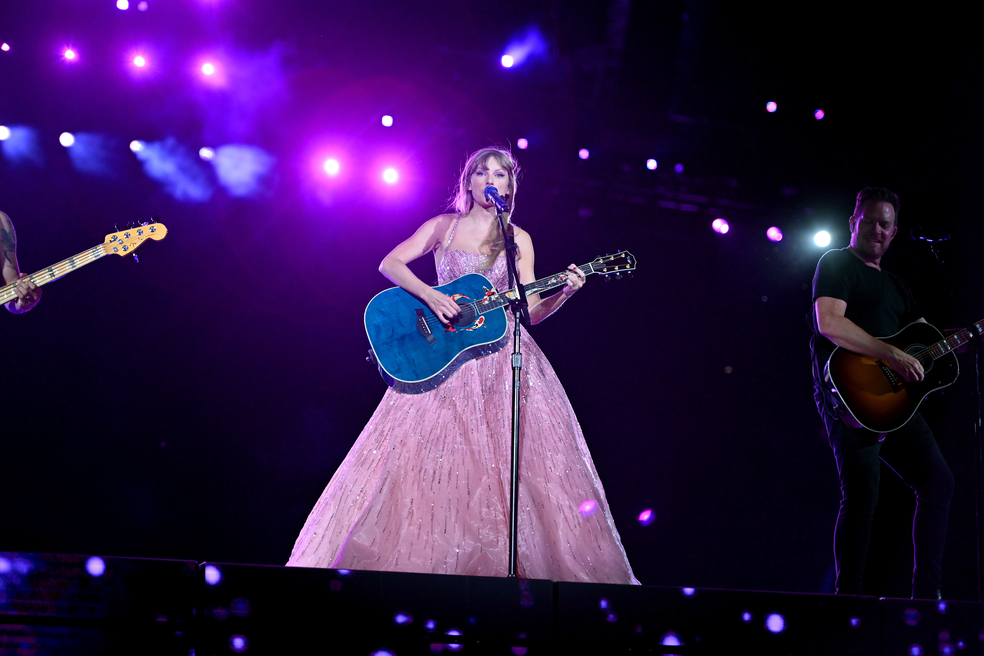 Taylor Swift in a pink-purple dress during The Eras Tour