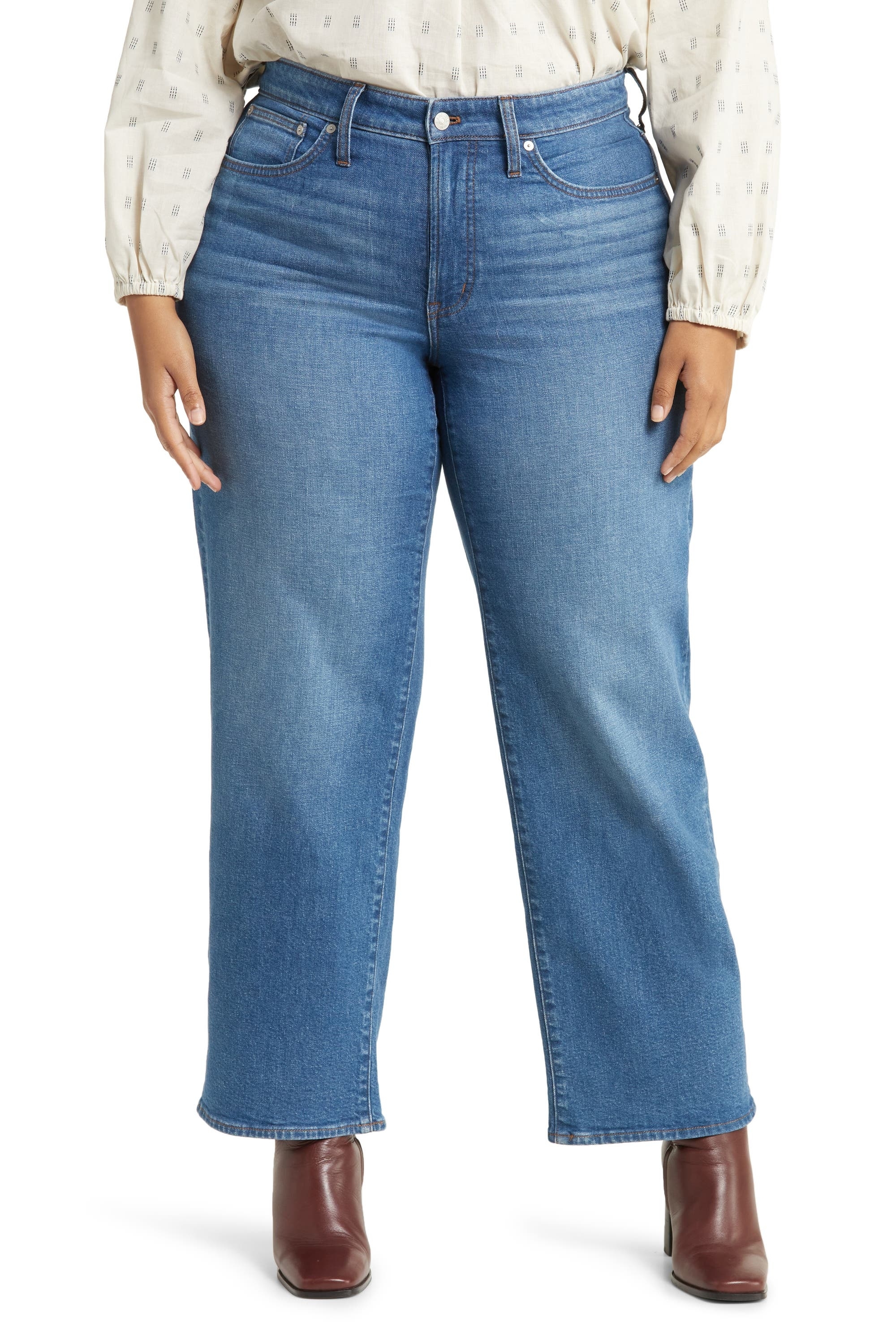 model in medium wash wide-legged jeans