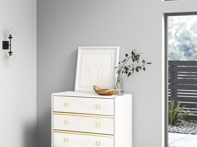 white three-drawer dresser with gold-tone square-shaped drawer handles