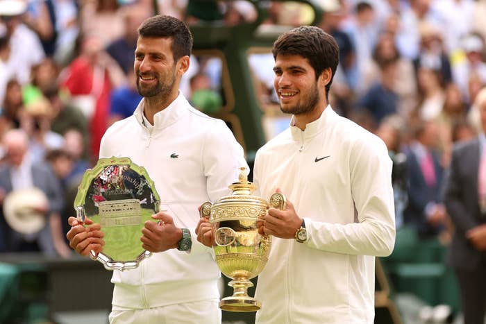 Carlos and Novak holding their trophies